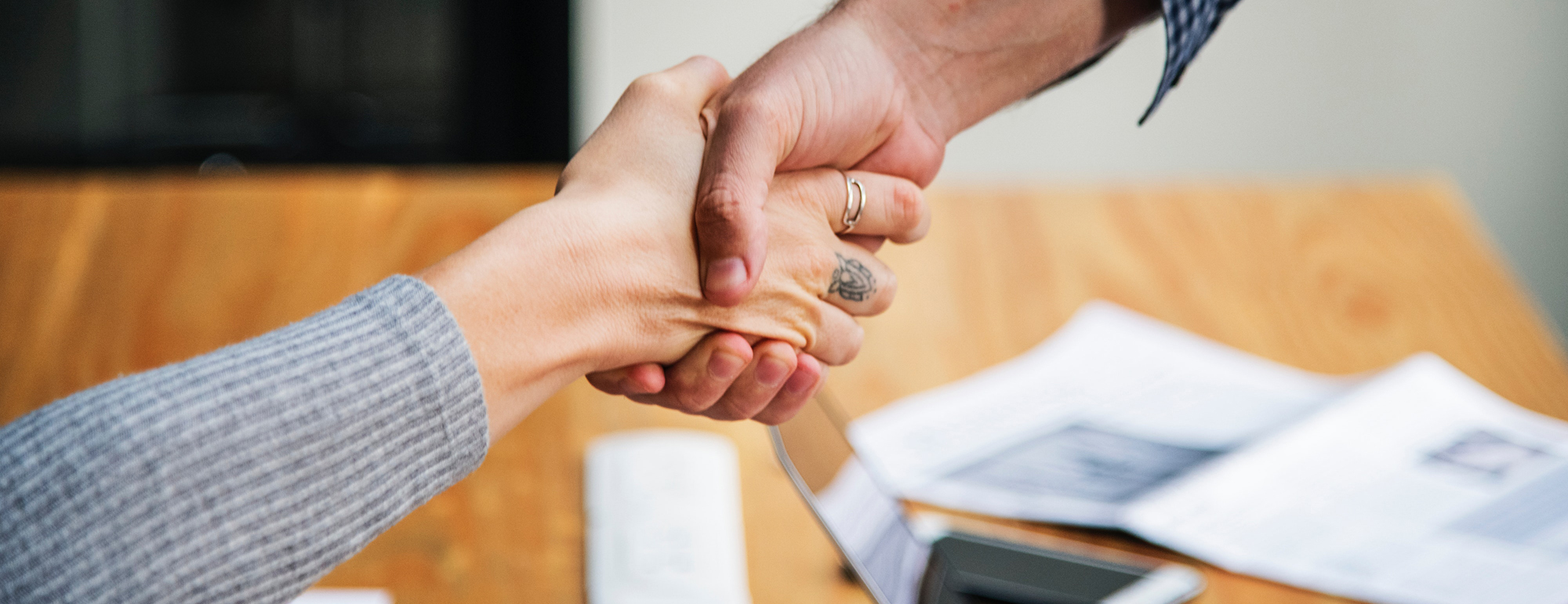 handshake over a table